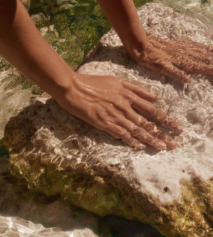 Hands in shallow water